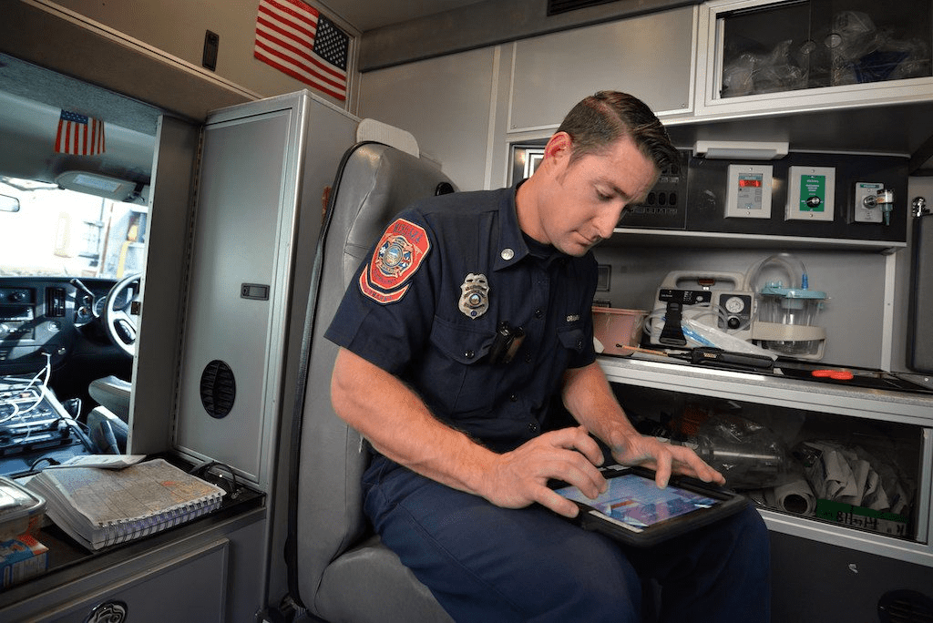 A police officer working on digital device