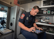A police officer working on digital device